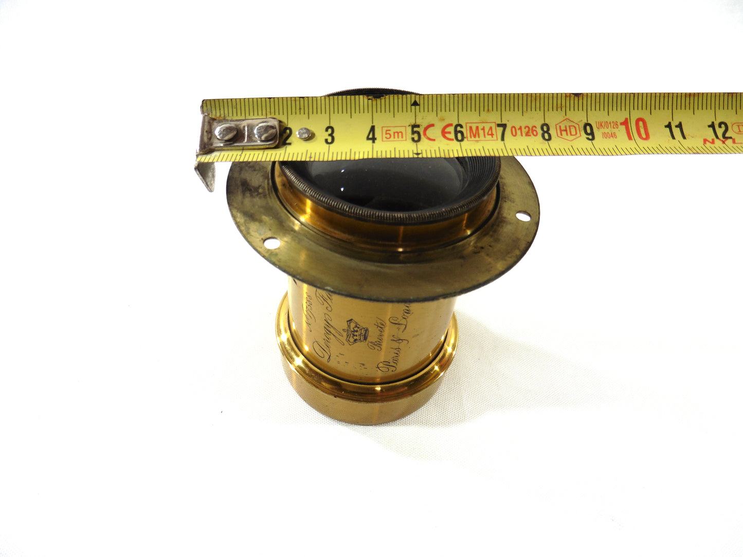 Derogy N°4 avec bague, objectif en laiton, focale environ 290mm, ouverture estimative F/8, hauteur objectif 8,5cm, diamètre pare-soleil 6cm, diamètre bague 8cm, diamètre lentille avant 4cm.